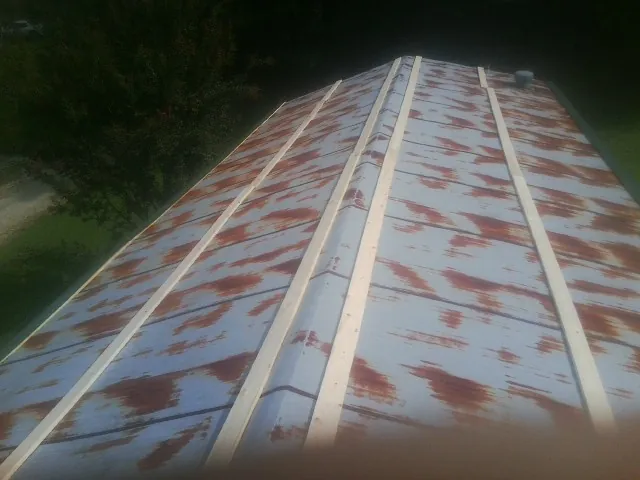 Rusted metal roof panels with new wood purlins before replacement — Storm Damage Roof Repair in Ithaca by Roofing Brothers
